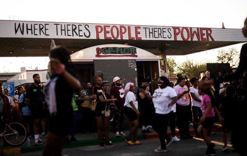 People gather for a vigil at George Floyd Square on May 25, 2023 in Minneapolis, Minnesota outside the former Speedway Station the city is looking to redevelop as a community space.