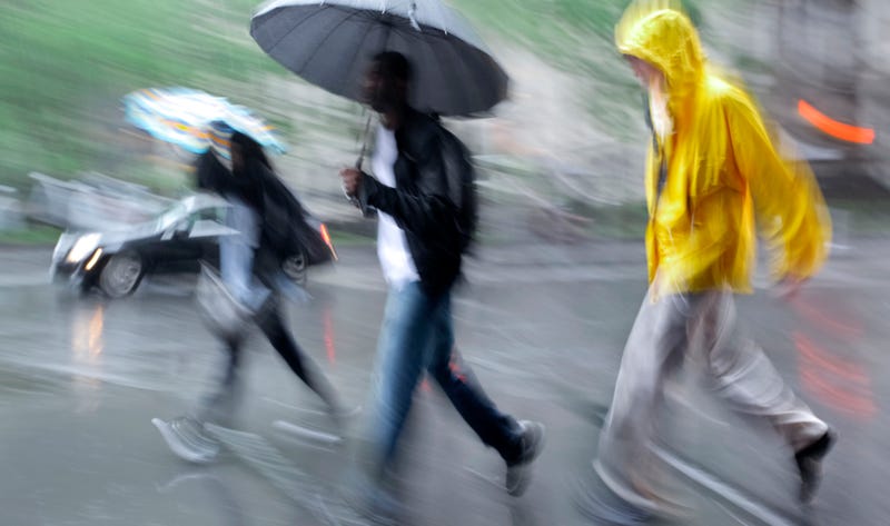 people walking in the street on a rainy day motion blurred