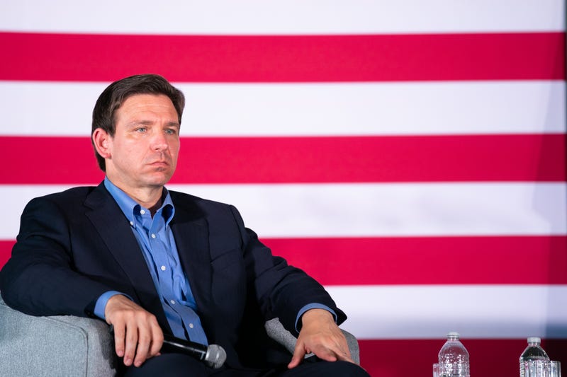 ron desantis sits onstage