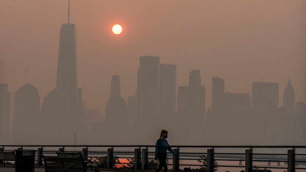 Why do wildfires cause hazy orange skies?