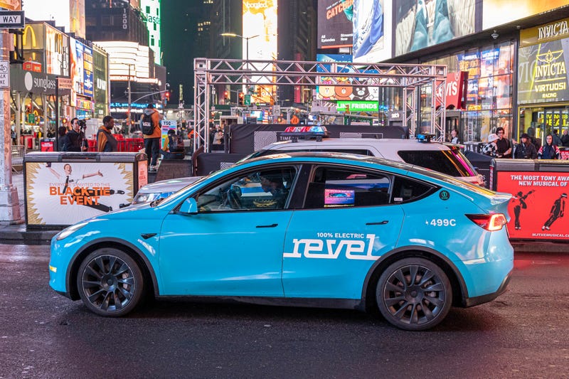 Revel electric car taxi service in the streets of New York City in Times Square. Using modified Tesla vehicles, the rideshare app claims that all its cars are electric and emissions-free.