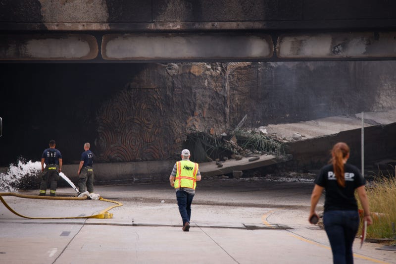 Firefighters work at a collapsed portion of Interstate 95, caused by a large vehicle fire, in Philadelphia, Pennsylvania, on June 11, 2023.