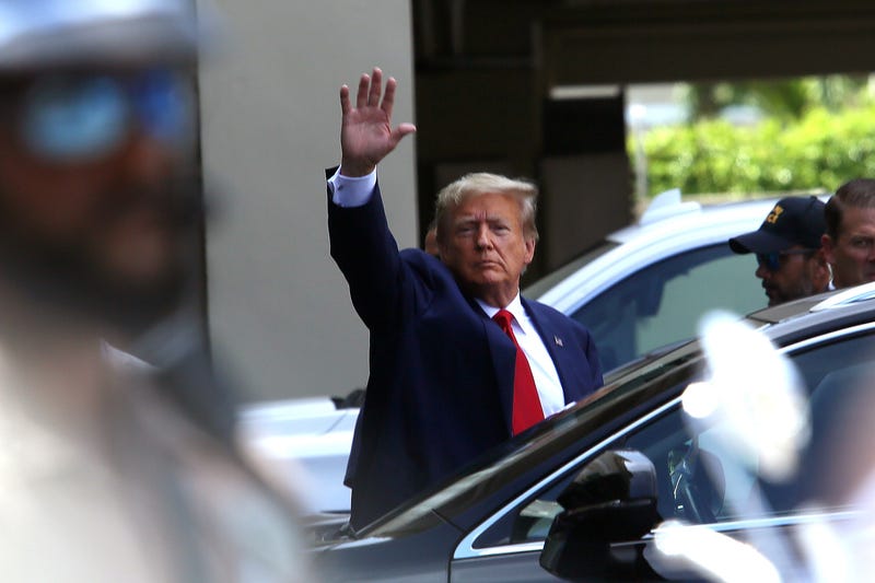 Former U.S. President Donald Trump waves as he makes a visit to the Cuban restaurant Versailles after he appeared for his arraignment on June 13, 2023 in Miami, Florida.