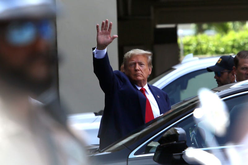 Former U.S. President Donald Trump waves as he makes a visit to the Cuban restaurant Versailles after he appeared for his arraignment on June 13, 2023 in Miami, Florida.