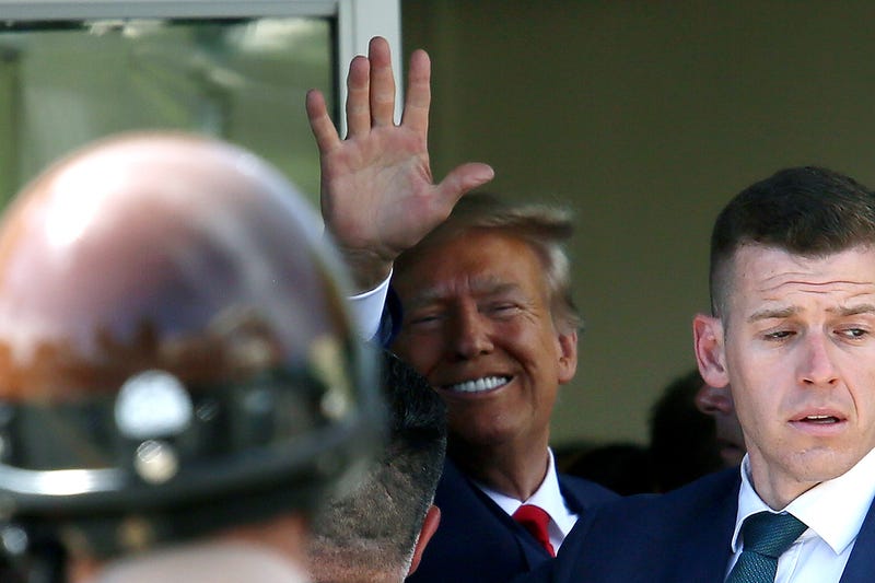 trump waves at camera