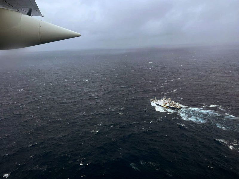 In this U.S. Coast Guard handout, a Coast Guard Air Station Elizabeth City, North Carolina HC-130 Hercules airplane flies over the French research vessel, L'Atalante approximately 900 miles East of Cape Cod during the search for the 21-foot submersible, Titan, June 21, 2023 over the Atlantic Ocean. 