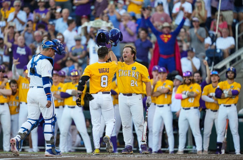 Gavin Dugas #8 of the LSU Tigers celebrates with Cade Beloso #24 after hitting a home run during the third inning of Game 1 of the NCAA College World Series baseball finals against the Florida Gators at Charles Schwab Field on June 24, 2023 in Omaha, Nebraska.