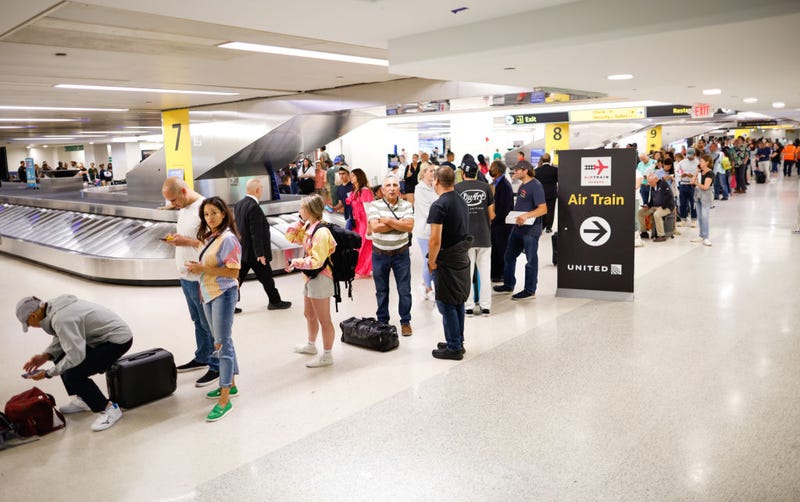 Individuals assemble and await the rescheduling of their flights at Newark International Airport on June 27, 2023 in Newark, New Jersey.