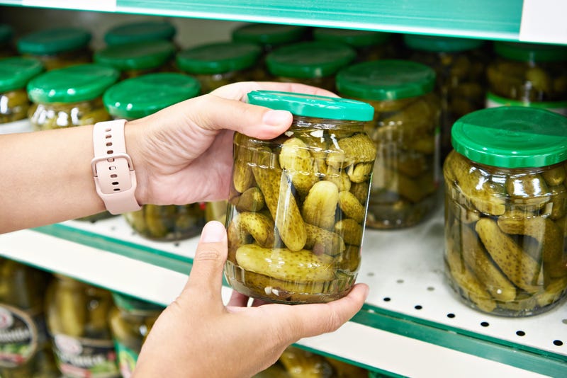 Pickles in the hands of a buyer in a store