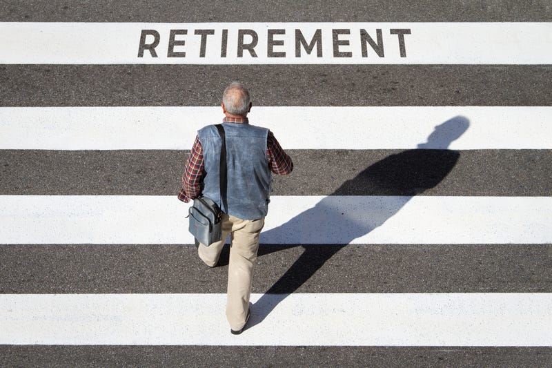 Scene of a senior man walking towards retirement text