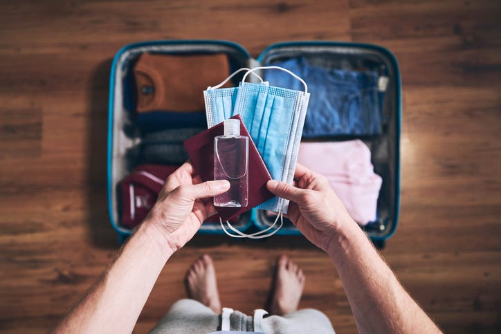 Person packing a mask for a trip.