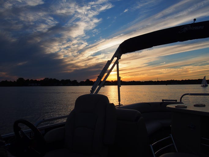 pontoon boat on a lake in the evening