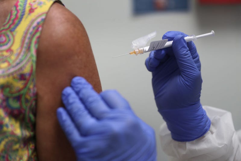 Lisa Taylor receives a COVID-19 vaccination from RN Jose Muniz as she takes part in a vaccine study at Research Centers of America on August 07, 2020 in Hollywood, Florida.