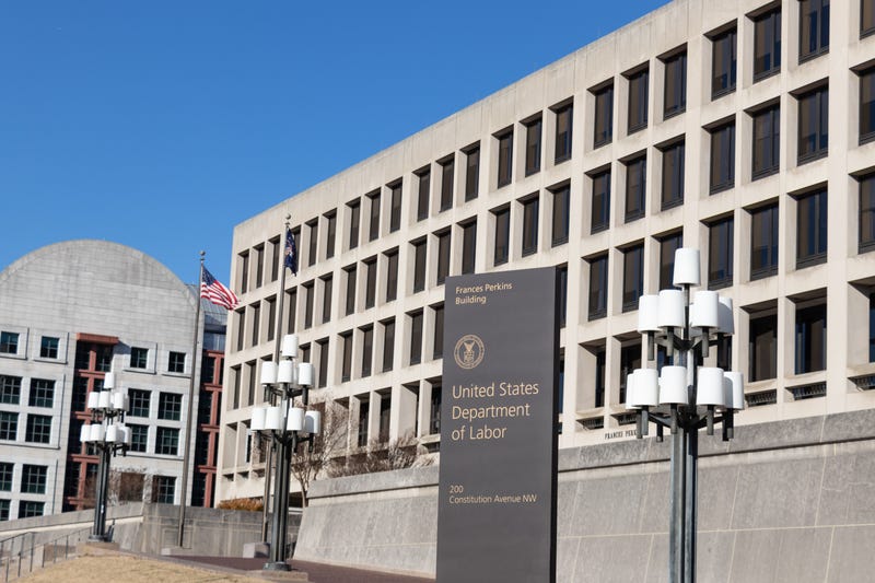 tall concrete building with a sign in front that says united states department of labor