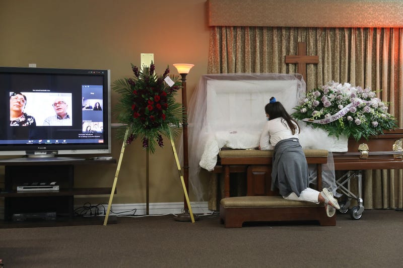 Asare Amaya,10 mourns for her father, German Amaya as family and friends are seen via a Zoom broadcast as they mourn together during the wake ceremony at the Maspons Funeral Home on August 08, 2020 in Miami, Florida.