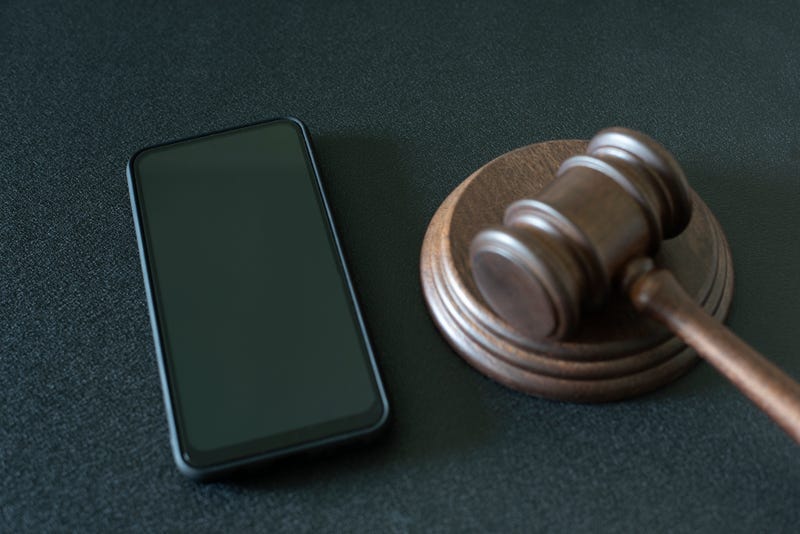 Stock image of gavel and cell phone