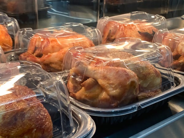 Rotisserie chickens on display in a store