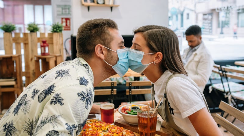 Couple kissing in masks