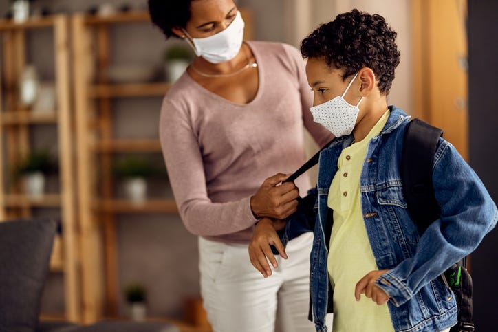 mother helps son get ready for school