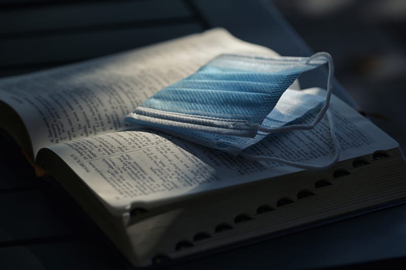 A Medical Respiratory Mask On Holy Bible