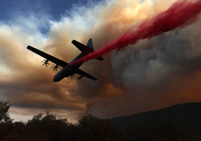 A Modular Airborne Fire Fighting Systems (MAFFS) equipped C-130 aircraft drops retardant ahead of the LNU Lightning Complex fire on August 20, 2020 in Healdsburg, California. 