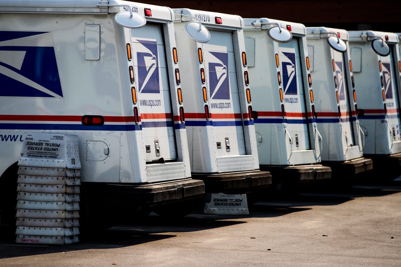 Mail trucks are seen as rally goers gather at a post office to protest the Trump administration's handling of the US Postal System at the Rally to Save the Post Office on August 22, 2020 in Los Angeles, California.