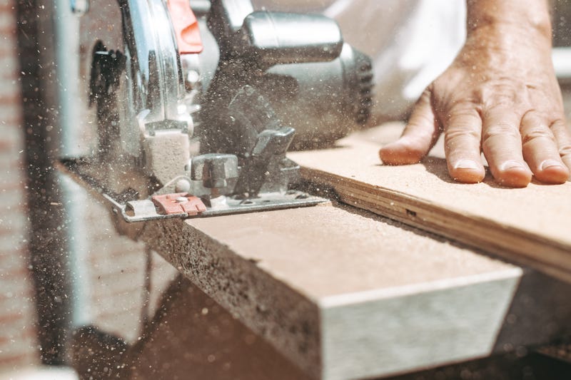 man cutting wood