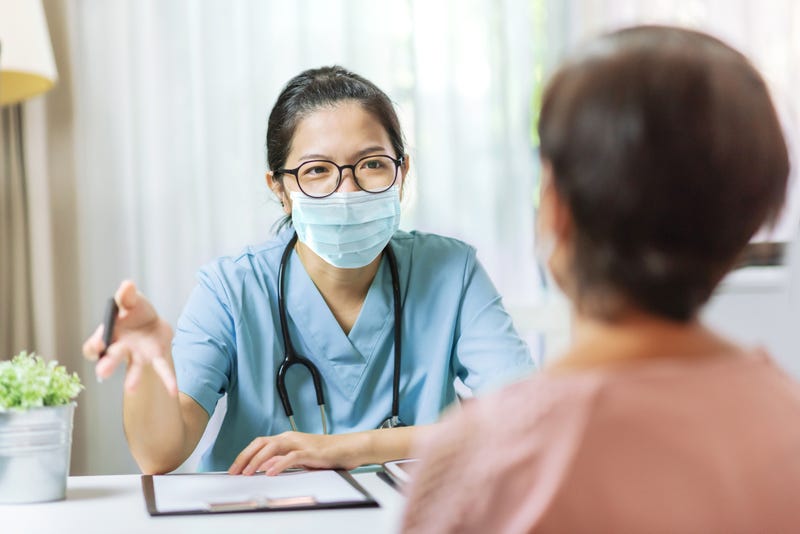 A doctor talking with a patient.