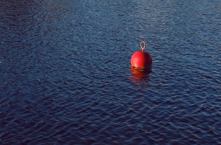 file photo of a red buoy on a lake