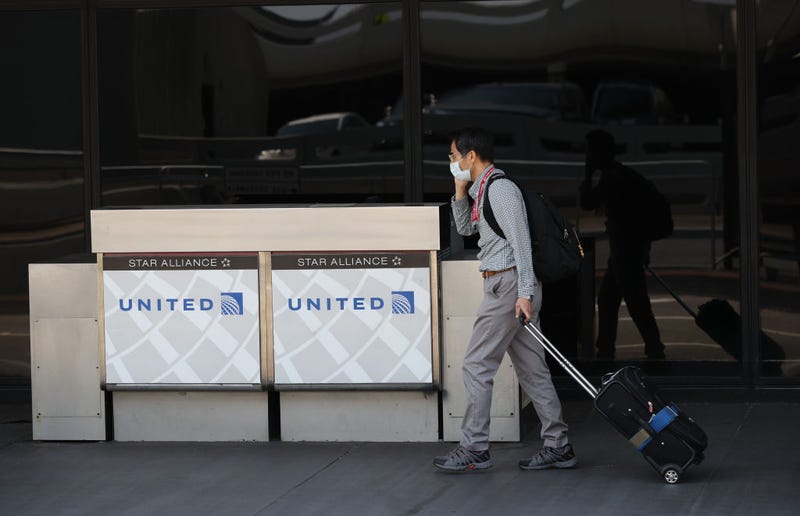 A United Airlines passenger walks by a closed curbside check in booth at San Francisco International Airport on September 02, 2020 in San Francisco, California.