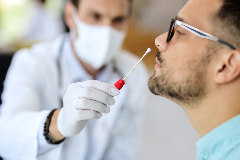 Man getting COVID-19 test stock photo. 