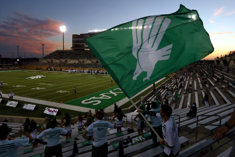 Supporters of the North Texas Mean Green wave the team flag from the stands during the game against the Houston Baptist Huskies at Apogee Stadium on Sept. 5, 2020 in Denton, Texas.