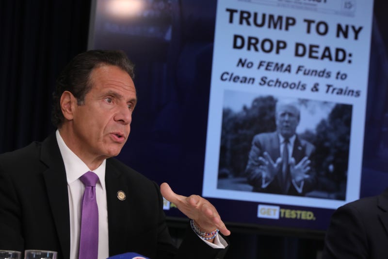 A mock up of a newspaper headline and photo of U.S. President Donald Trump is displayed on a screen as New York state Gov. Andrew Cuomo criticizes Trump's handling of COVID-19 at a news conference on September 08, 2020 in New York City. Cuomo, though easing restrictions on casinos and malls throughout the state, has declined to do so for indoor dining in restaurants in New York City despite pressure from business owners, citing struggles by the city to enforce the state's previous orders.