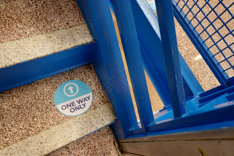 A sign on a stairway at King Elementary School encourages social distancing as the school works to maintain a safe environment during the coronavirus pandemic on September 08, 2020 in Chicago, Illinois. Students at King Elementary and the rest of Chicago public schools started classes today remotely because of COVID-19 concerns. Teachers have the option of teaching from home or from their classrooms. 