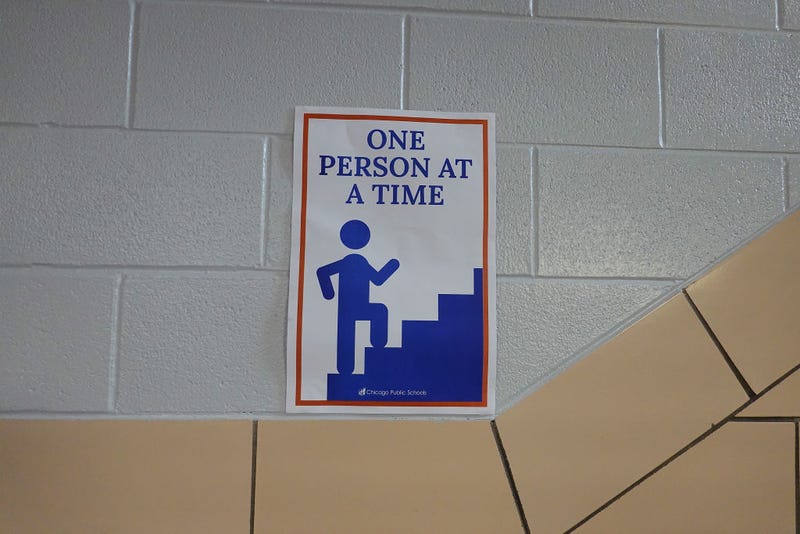 A sign in a hallway at King Elementary School encourages social distancing as the school works to maintain a safe environment during the coronavirus pandemic on September 08, 2020 in Chicago, Illinois.