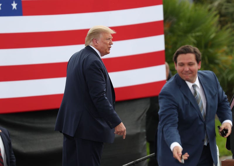 President Donald Trump exits from the stage after speaking about the environment during a stop at the Jupiter Inlet Lighthouse as Florida Governor Ron DeSantis hands out pens to people in the crowd on September 08, 2020 in Jupiter, Florida.