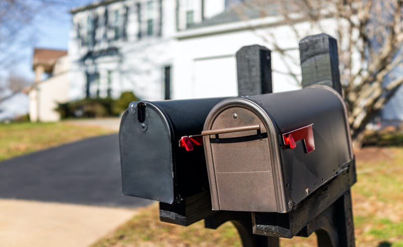 Closeup of two flag mailboxes at single family home