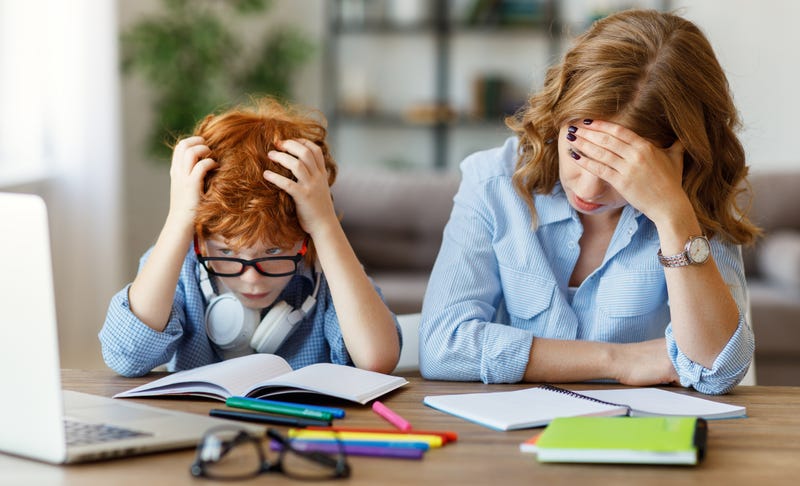 Mother is stressed and has headache and helping son with homework