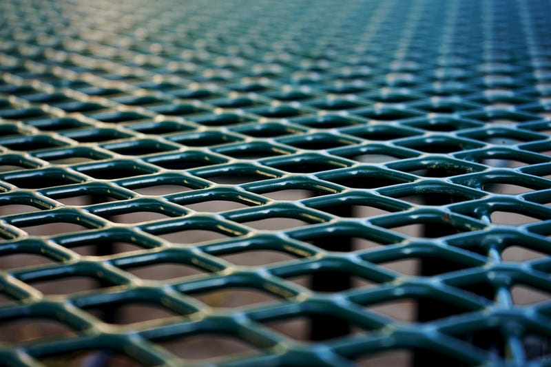 Green metal picnic table in closeup