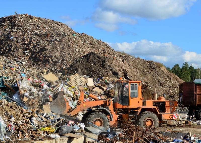 Front-end loader works in a landfill for the disposal of construction waste