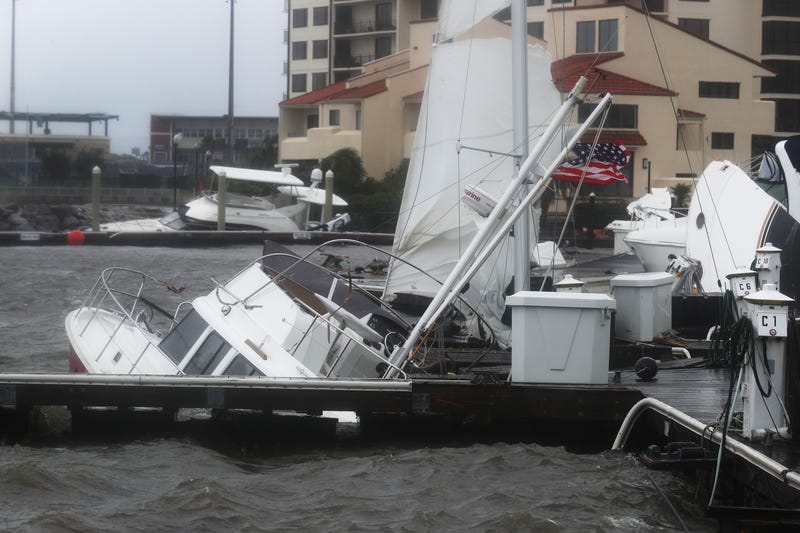 Hurricane sinks boats tied to pier in Pensacola