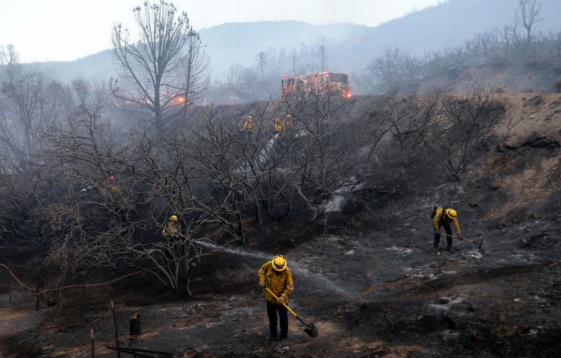 FILE - Firefighters work as the Bobcat Fire continues to burn on Sept. 19, 2020 near Valyermo, Calif. The Bobcat Fire has now scorched more than 91,000 acres and destroyed homes.