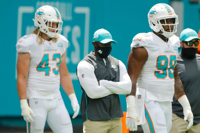 Brian Flores looks on from the sideline.