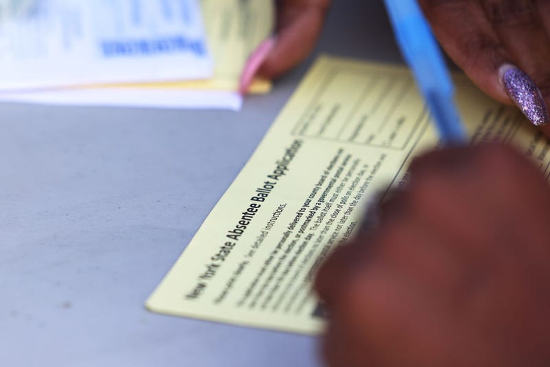 Shamarie McDonald fills out an absentee voter registration form on September 22, 2020 in the Crown Heights neighborhood of the Brooklyn borough of New York City.