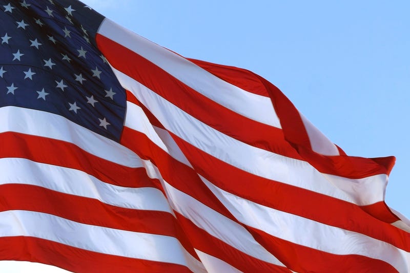 A brand new 30-by-60-foot American flag waved in the wind once again outside an Ottawa County car dealership to usher in the holiday weekend after thieves cut down the original flag five days ago.