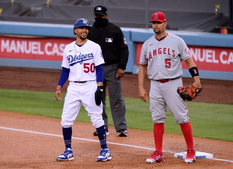 Dodgers star Mookie Betts talks with future Hall of Fame Angels first baseman Albert Pujols.