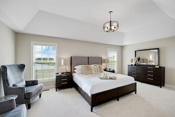 Wonderfully decorated master bedroom with tray ceiling