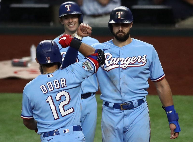Rougned Odor #12 of the Texas Rangers celebrates a three-run home run with Joey Gallo #13 and Nick Solak #15 against the Houston Astros in the fourth inning at Globe Life Field on September 27, 2020 in Arlington, Texas.
