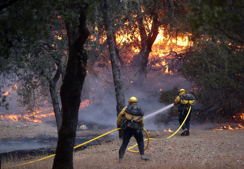 A Cal Fire firefighter battles the Glass Fire as it threatens the St. Helena Water Treatment Plant on September 27, 2020 in St. Helena, California.