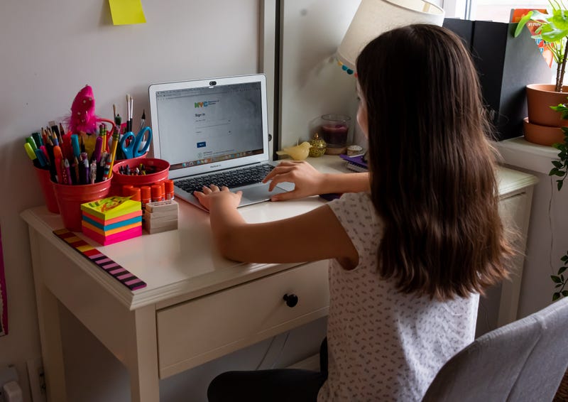 A New York City schools student sits in front of her computer during remote learning